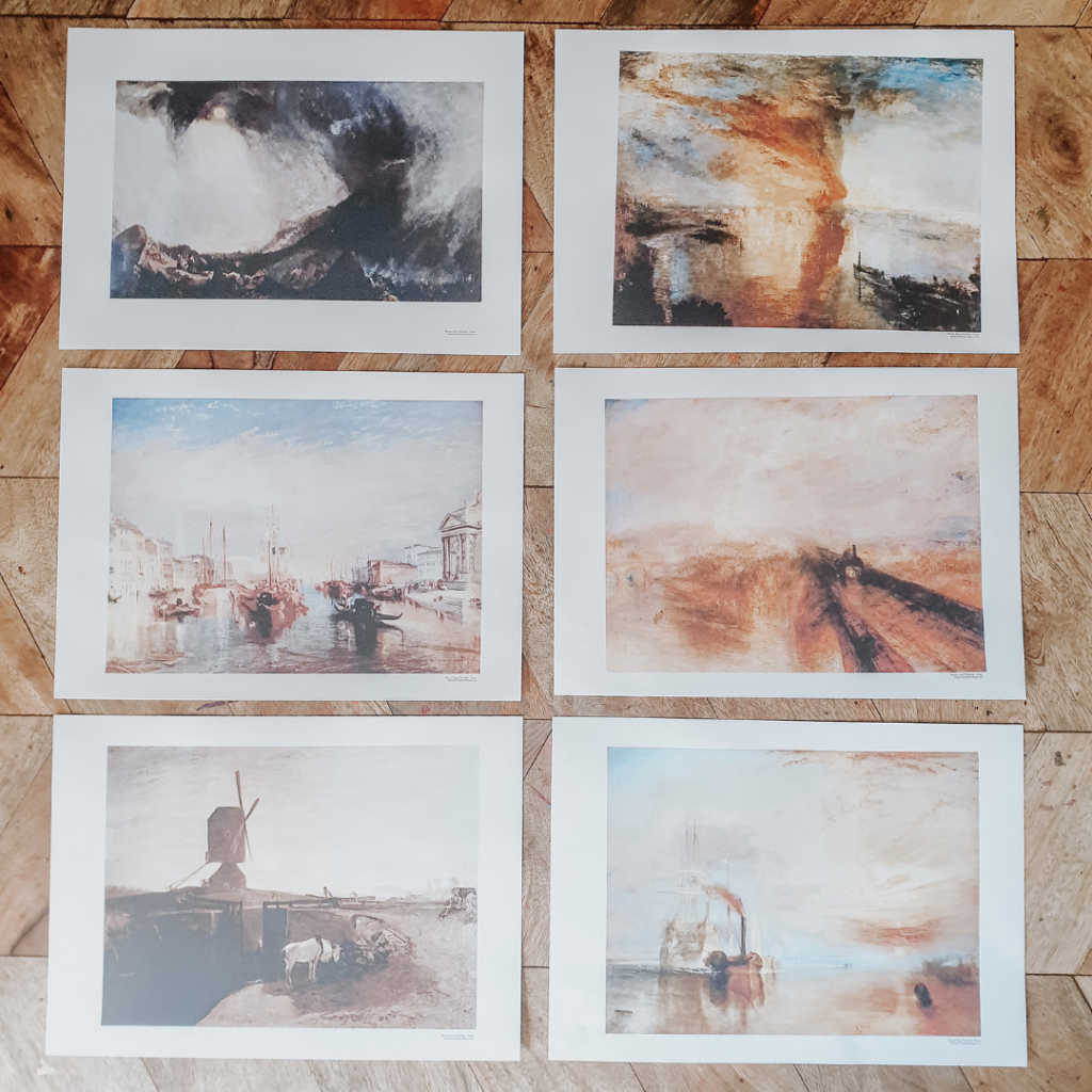 Six art prints are spread out on a table. They are all famous paintings by Turner printed on A4 card.