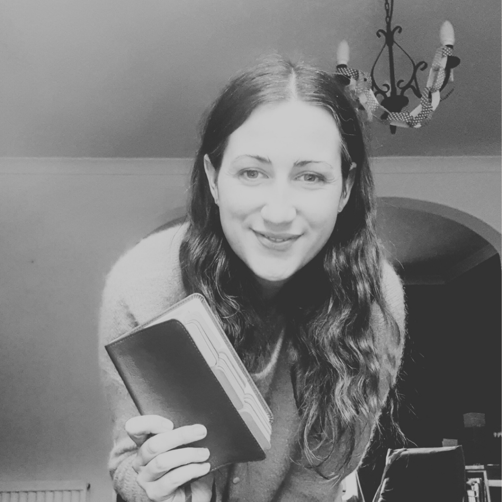 Smiling woman holds a bible in her hands